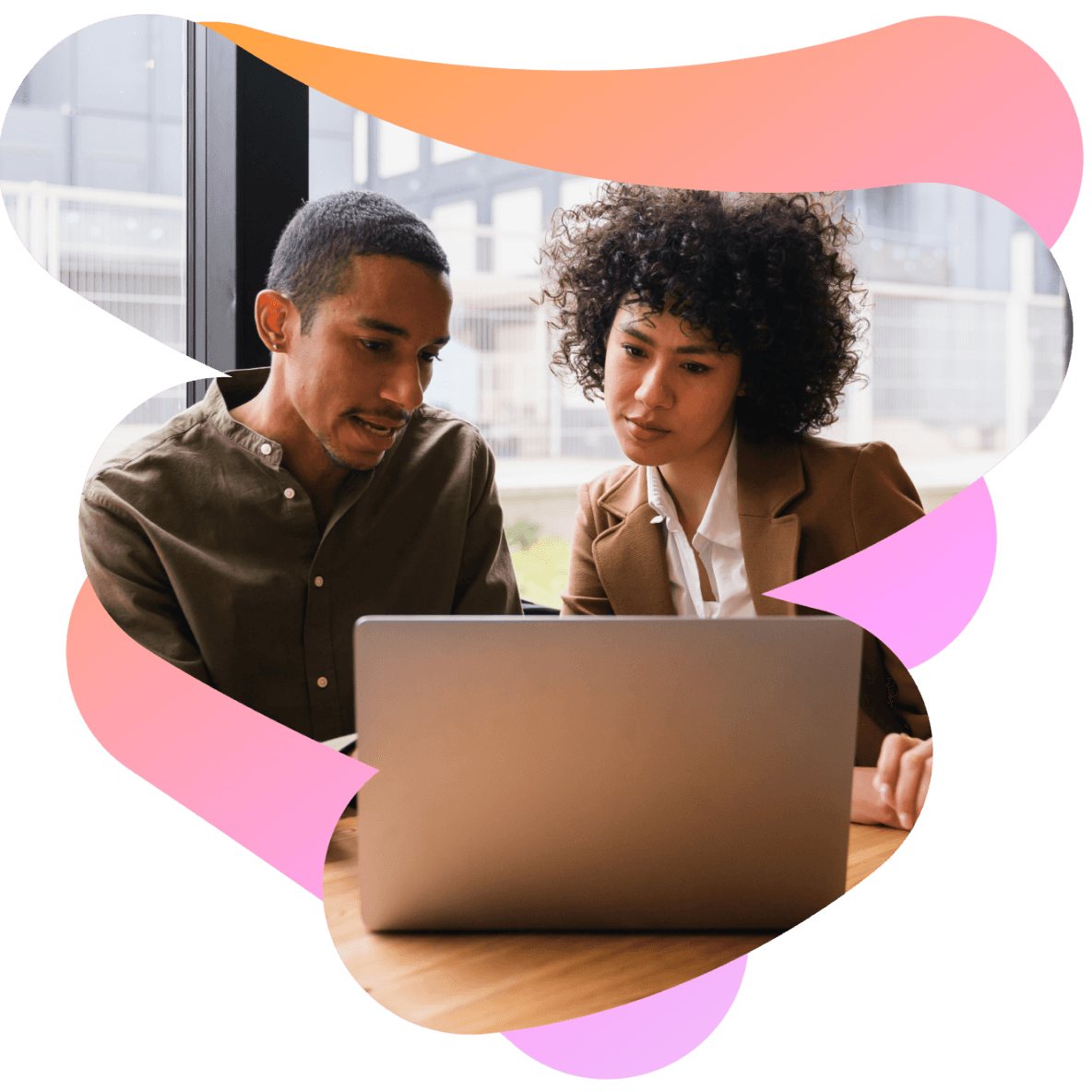 a man and a woman are looking at a laptop together