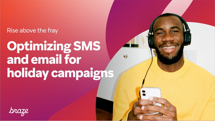 a man wearing headphones is holding a cell phone .