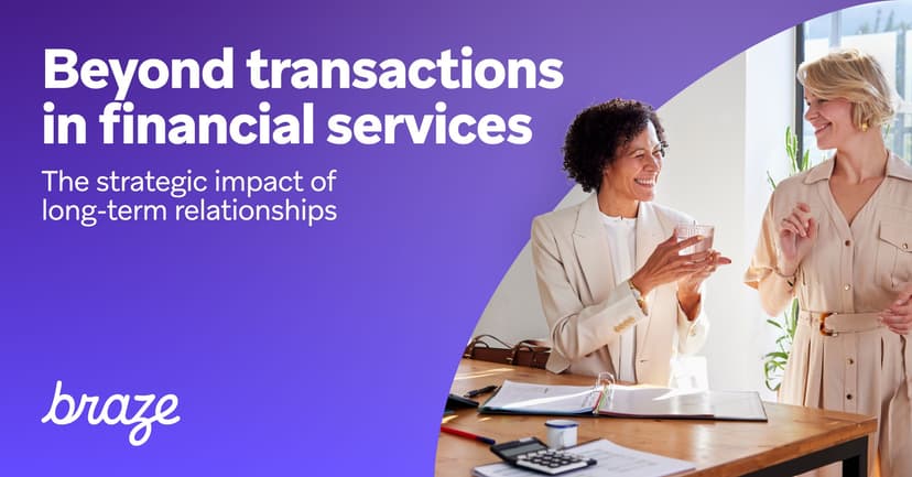 two women are talking to each other in an office while sitting at a desk .