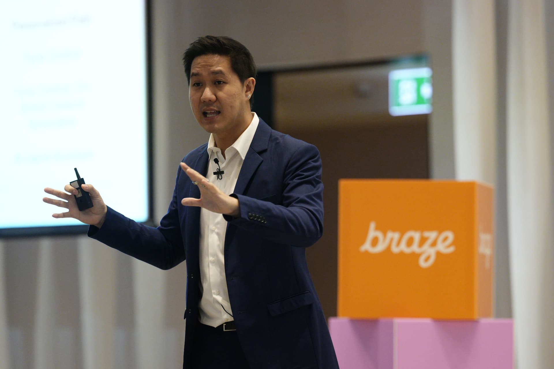 a man in a suit is giving a presentation in front of a podium .