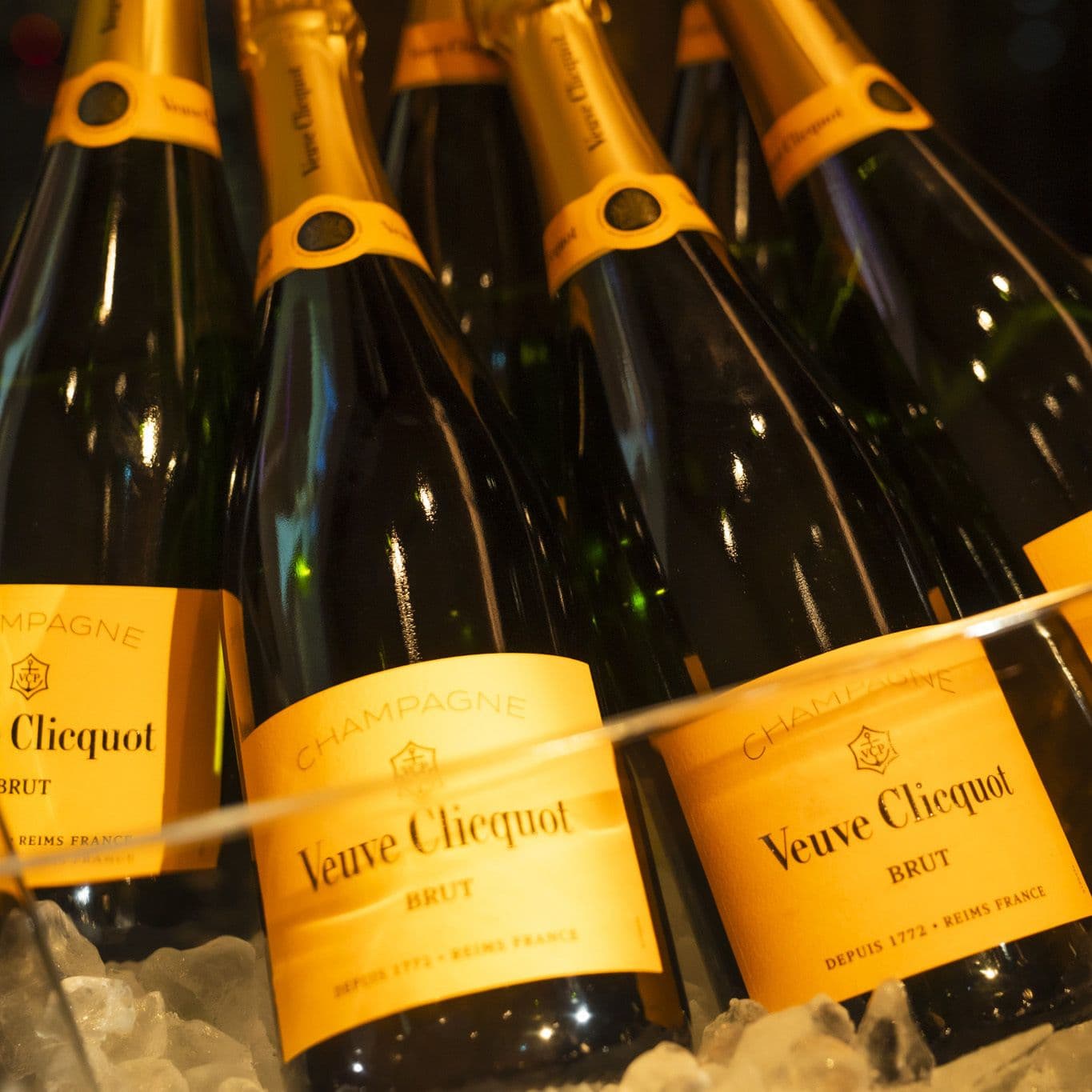 several bottles of veuve clicquot champagne are sitting on ice