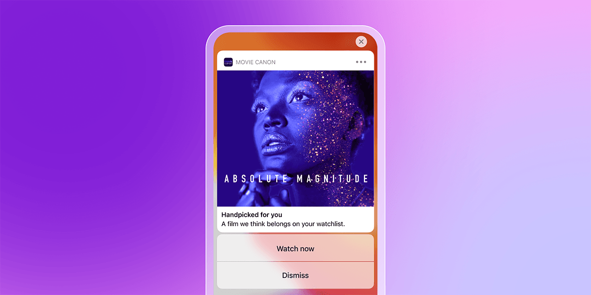 Mobile phone displaying a "MOVIE CANON" app notification for the film "ABSOLUTE MAGNITUDE", featuring a blue-toned person with glitter and "Watch now" and "Dismiss" buttons.