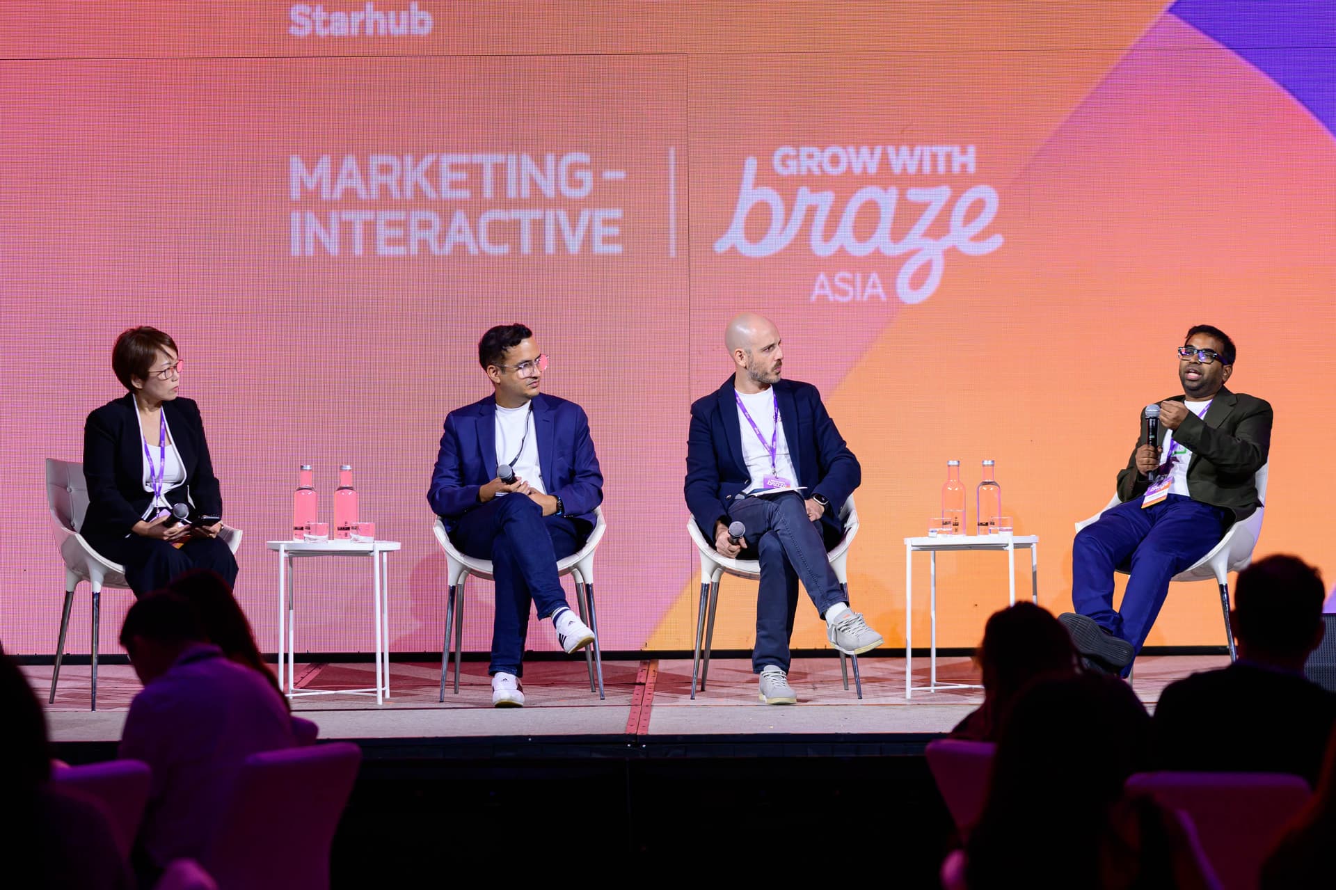 A panel of speakers on stage