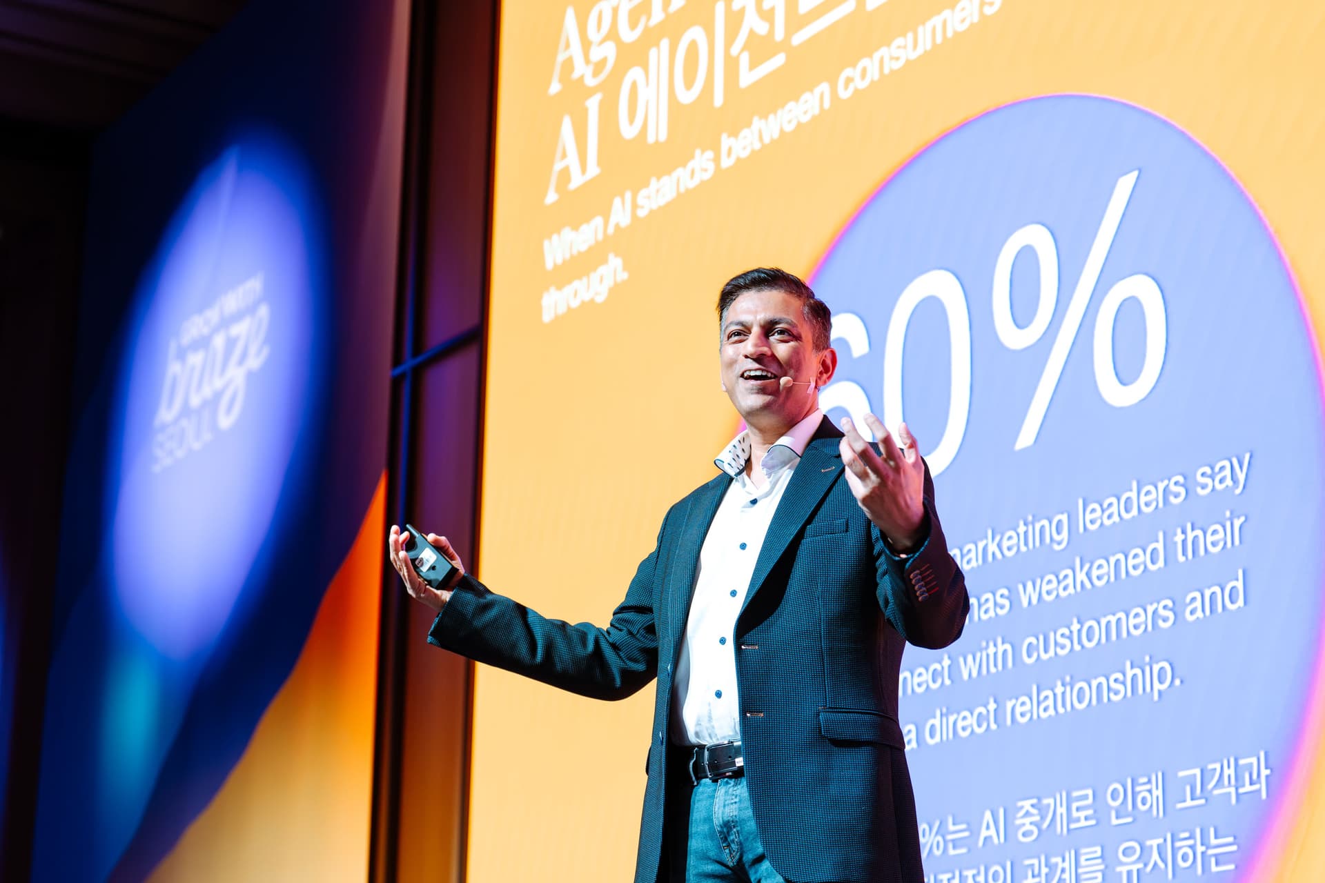 A man presents on a stage with "braze SEOUL" and a "60% AI" slide visible behind him.