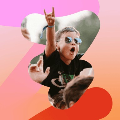 a young boy wearing sunglasses holds his hand up in the air