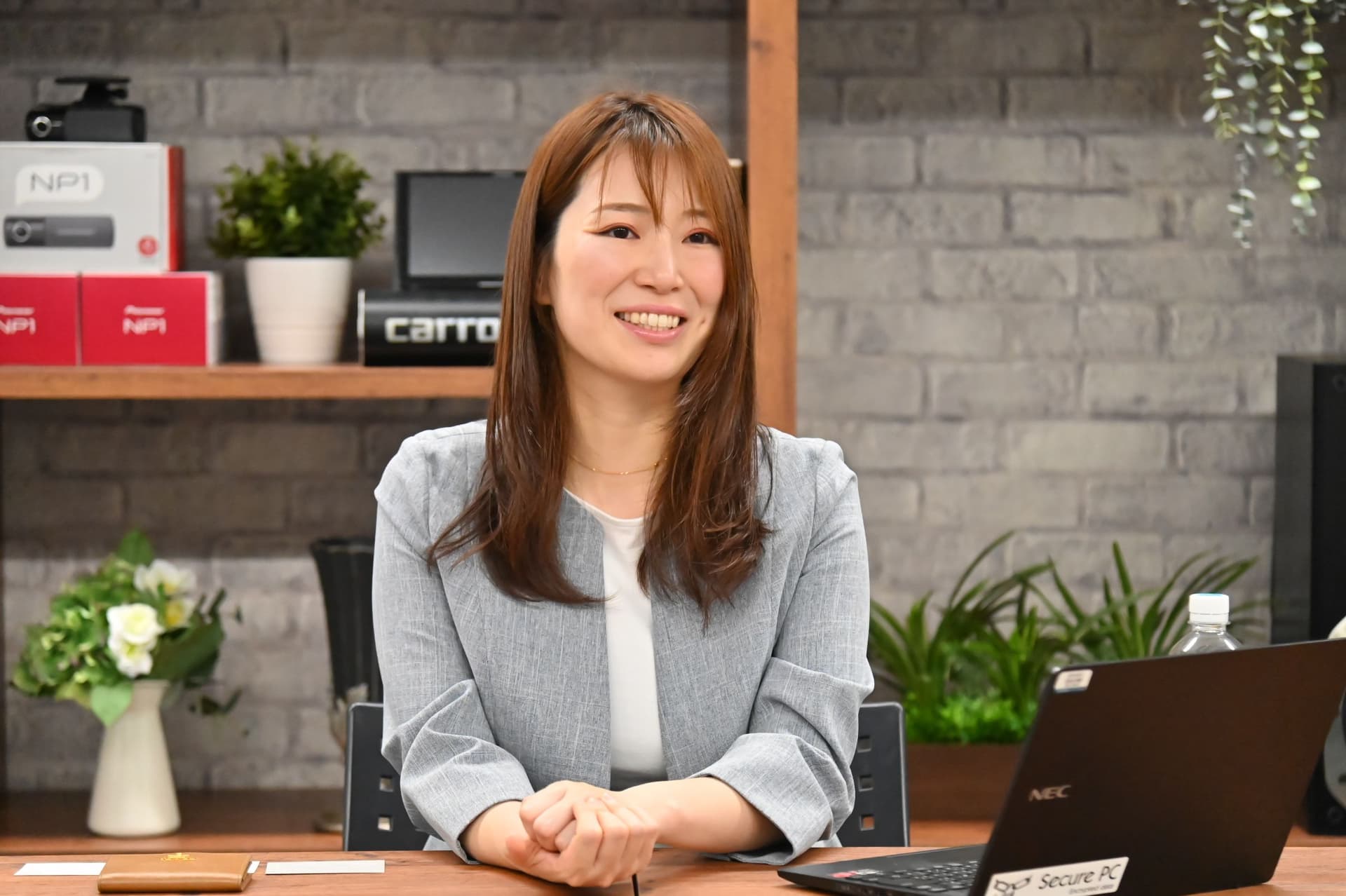 a woman is sitting at a desk in front of a laptop computer .