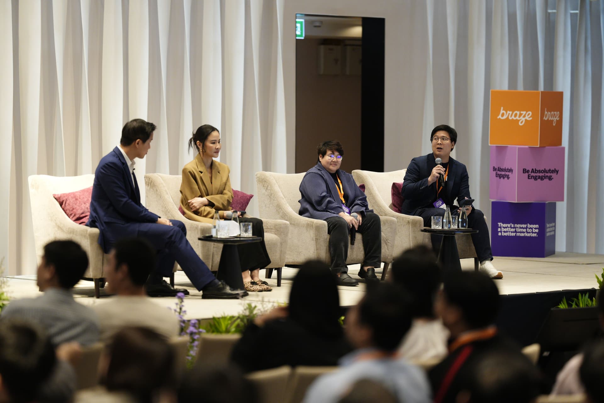 a group of people are sitting in chairs on a stage .