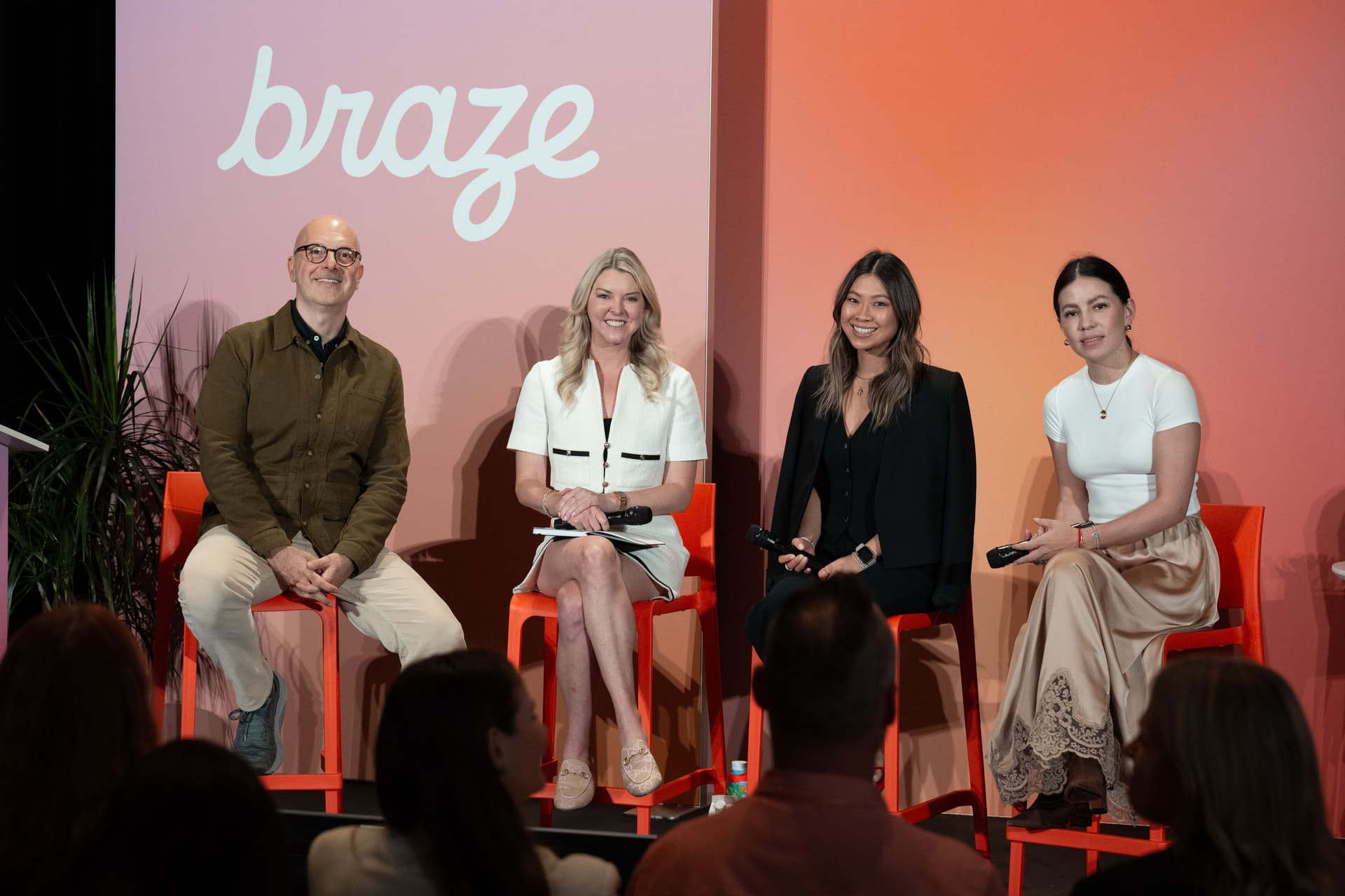 a group of people are sitting in chairs on a stage .