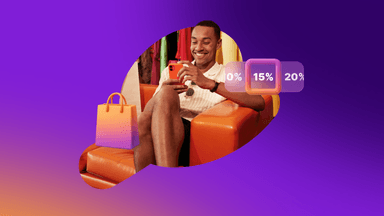 a man is sitting in an orange chair looking at his phone