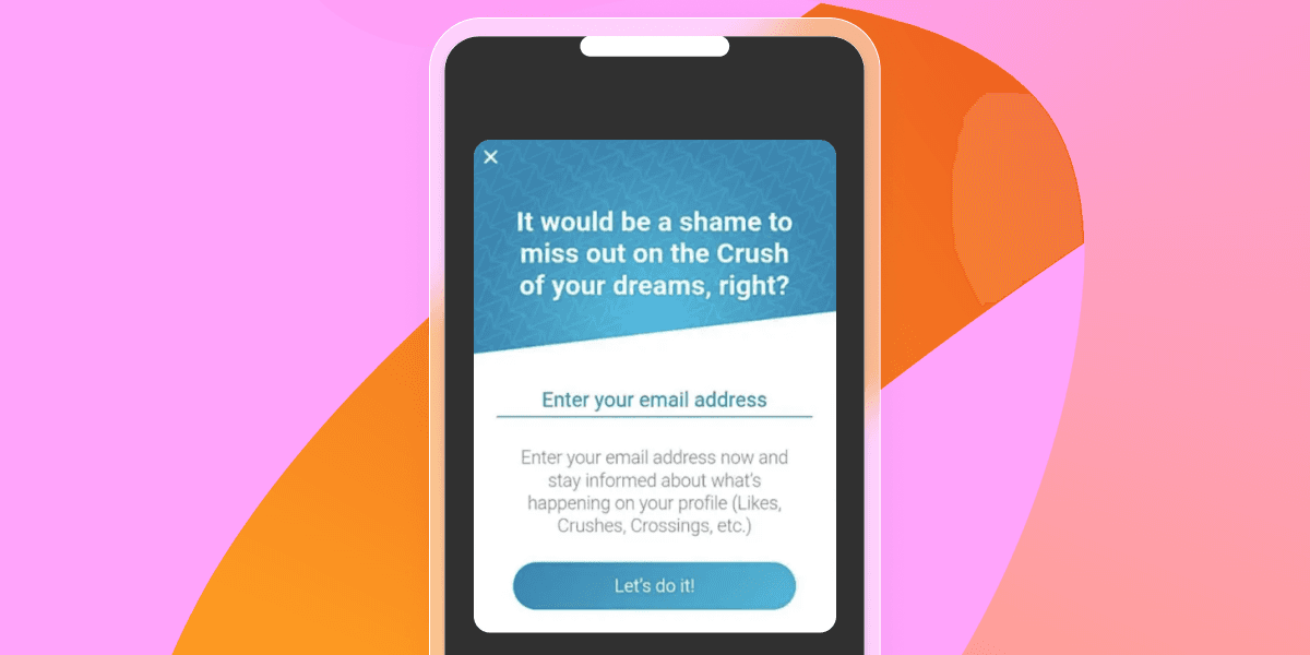 A smartphone displays a dating app pop-up urging email signup to receive updates on crushes and profile activity.