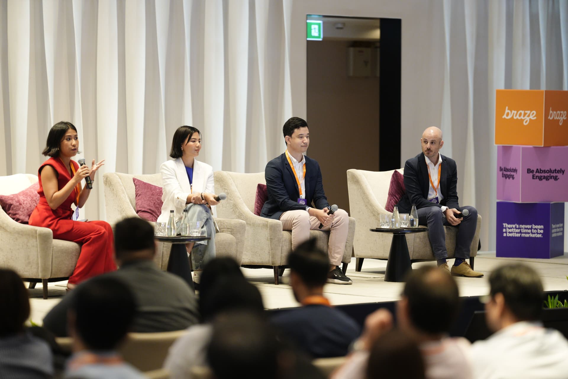 a group of people are sitting in chairs on a stage at a conference .