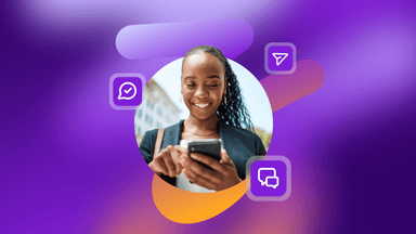 a woman is smiling while looking at her cell phone