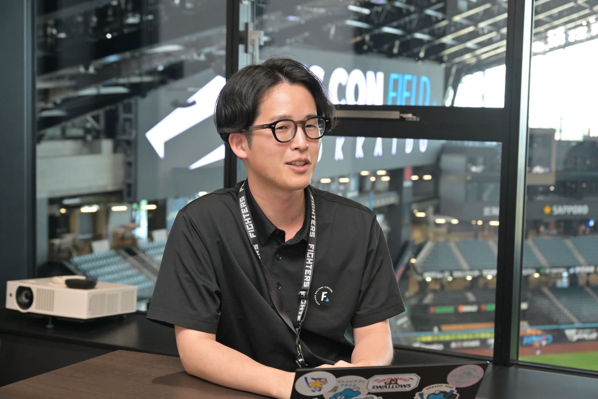 a man is sitting at a table with a laptop in front of a window .